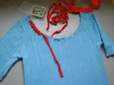 Jersey azul de punto con cuello cortado y tijeras.