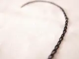 Un delicado corazón bordado con punto cadeneta sobre tela clara.