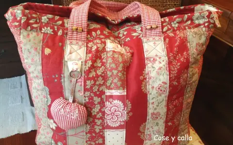 Bolso de tela patchwork, ideal para aprender como hacer bolsas de tela. Confeccionado con retales florales rojos y beige.