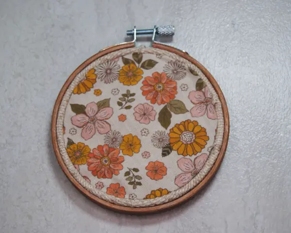 Bastidor con tela estampada de flores estilo retro. Ideal para crear patrones para bordar en bastidor y dar un toque vintage a tus creaciones.