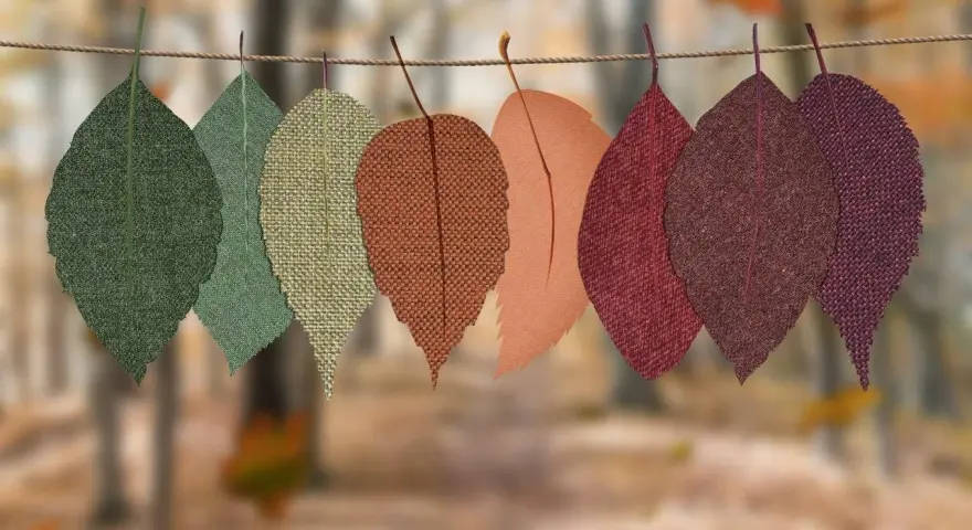 Hojas de tela de otoño colgadas en una cuerda. Ideas de cosas para hacer con telas, como manualidades o decoración.
